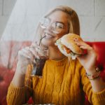 happy woman eating a burger
